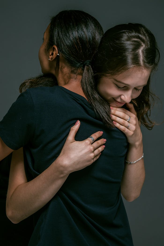 Two women hugging with affection and joy, symbolizing friendship and togetherness.